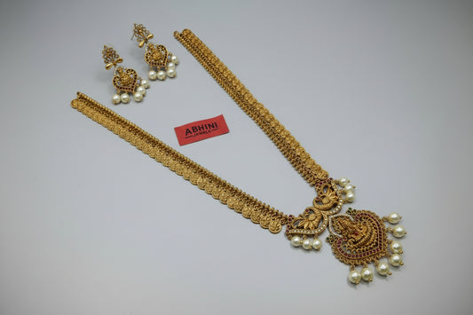 Gold necklace with heart-shaped pendants on a white background with 'ABHINI' branding.